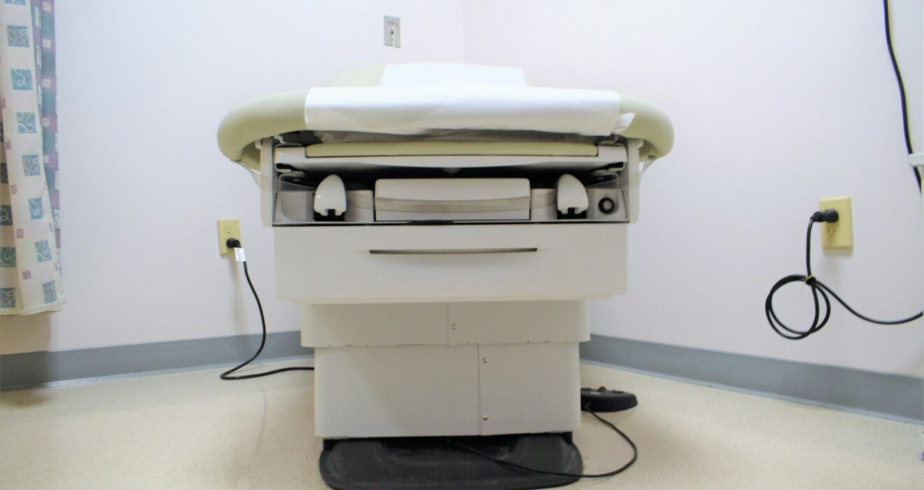 a hospital room with a bed and a charger