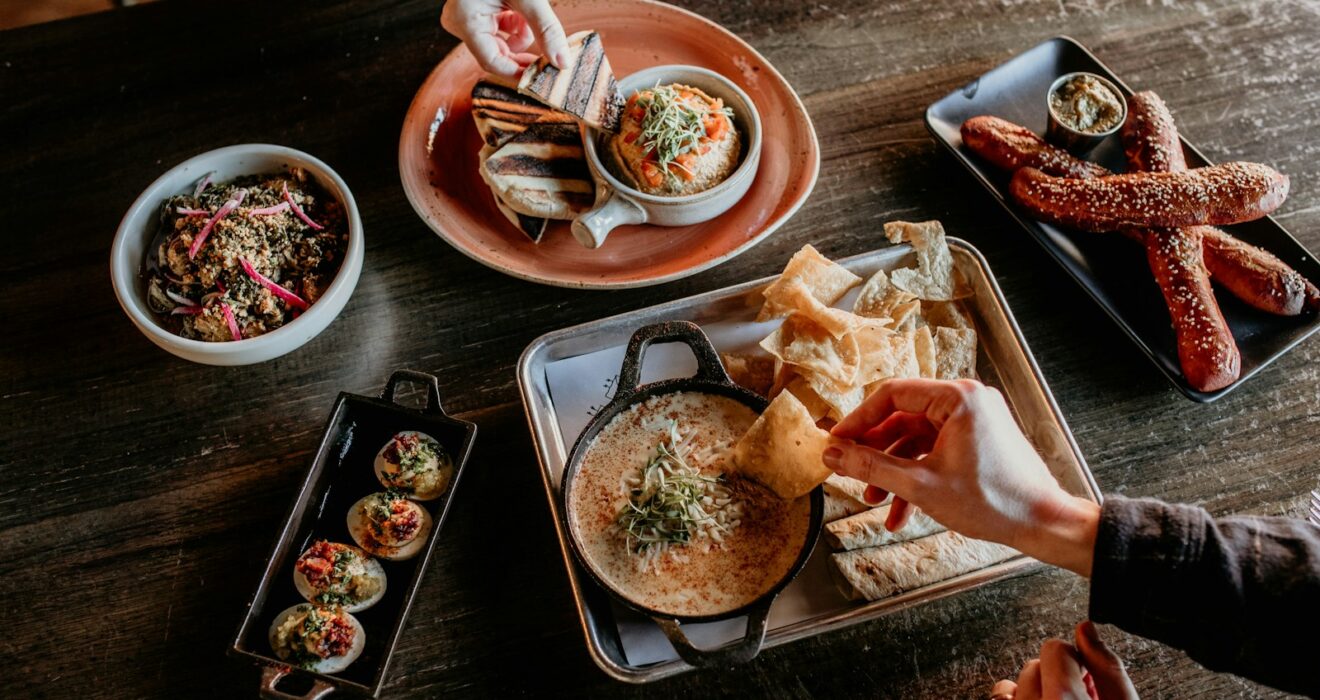 a table topped with plates and bowls of food