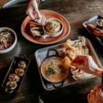 a table topped with plates and bowls of food